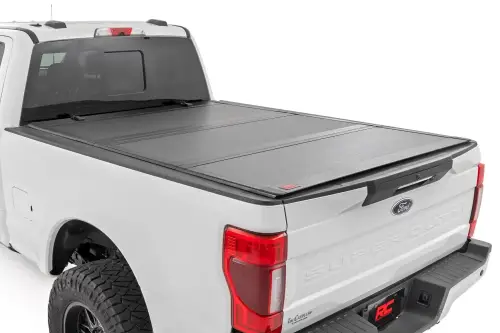 Rough Country - 49220651 | Rough Country Hard Tri-Fold Flip Up Bed Cover (2017-2024 F250, F350 Super Duty 2WD/4WD | 6'10" Bed)