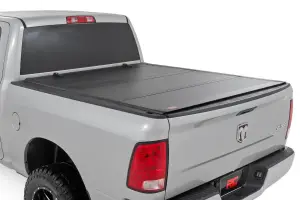 Rough Country - 49318650 | Rough Country Hard Tri-Fold Flip Up Tonneau Bed Cover For Ram 1500 (2010-2018 / 2500 (2010-2023) | 6'4" Bed - Image 1