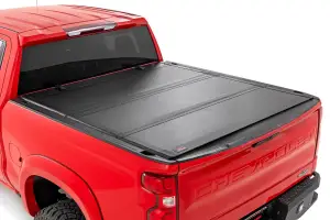Rough Country - 49120650 | Rough Country Hard Tri-Fold Flip Up Tonneau Bed Cover For Chevrolet Silverado 1500 / GMC Sierra 1500 | 2019-2023 | 6' 7" Bed - Image 1