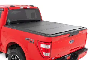 49225650_A | Rough Country Hard Tri Fold Flip Up Bed Cover For For F-150 & F-150 Raptor | 6'7" Bed