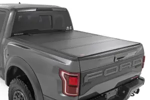 49225650 | Rough Country Hard Tri Fold Flip Up Bed Cover For For F-150 & F-150 Lightning | 6'7" Bed